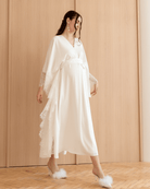 A dynamic walking shot of the Cotton Kaftan, capturing the effortless elegance and movement of the natural material.