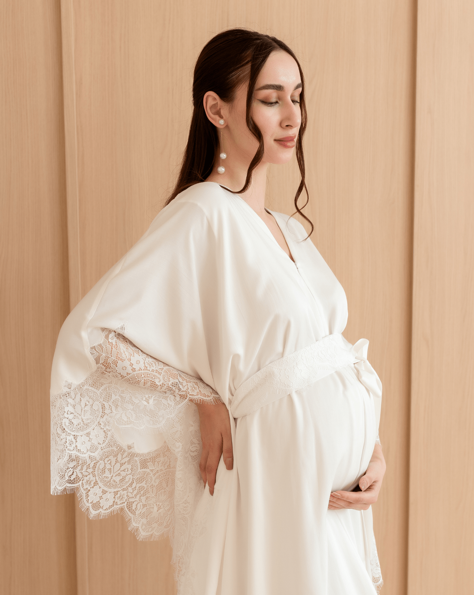 A side view of the maternity ensemble, emphasizing the natural drape and the discreet front zipper for nursing.