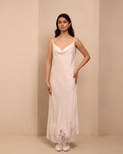 A static shot of the white nightdress, featuring a graceful neckline and delicate adjustable straps.