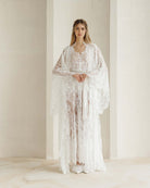Full-length view of the lace ensemble with hands at the waist, highlighting the refined and light silhouette.