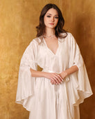 Portrait-focused shot of the bridal ensemble, showcasing the refined lace embellished sleeves and soft silk texture.