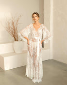 Model posing with hands on hips to showcase the voluminous and dramatic lace sleeves of the Flora nightdress.