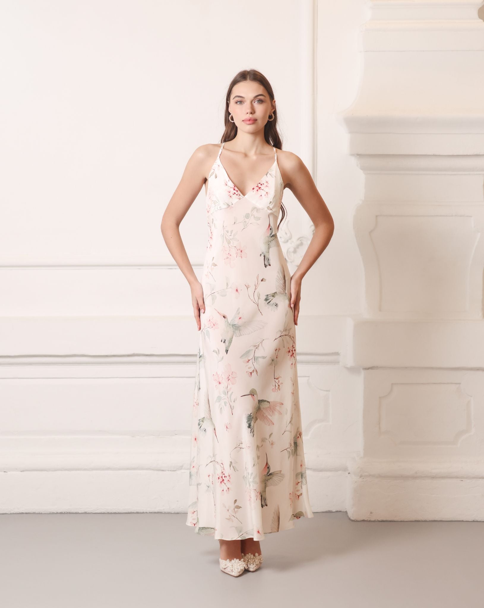 Elegant silk crepe nightdress with hands on the waist, showcasing the artistic garden birds print and V-neckline.
