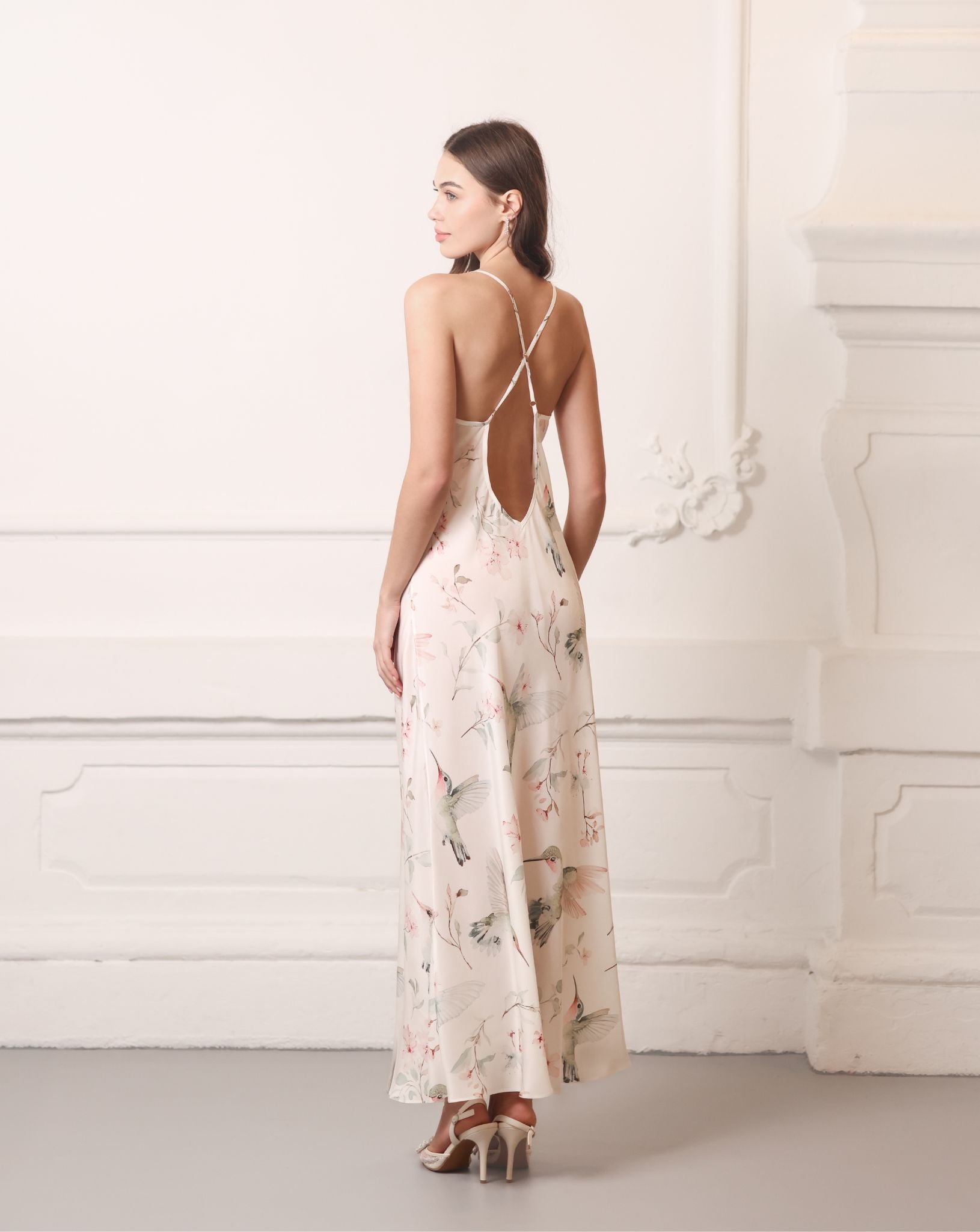 Back view of the silk nightgown highlighting crisscross straps and a mid-open V-cut for a sophisticated look.