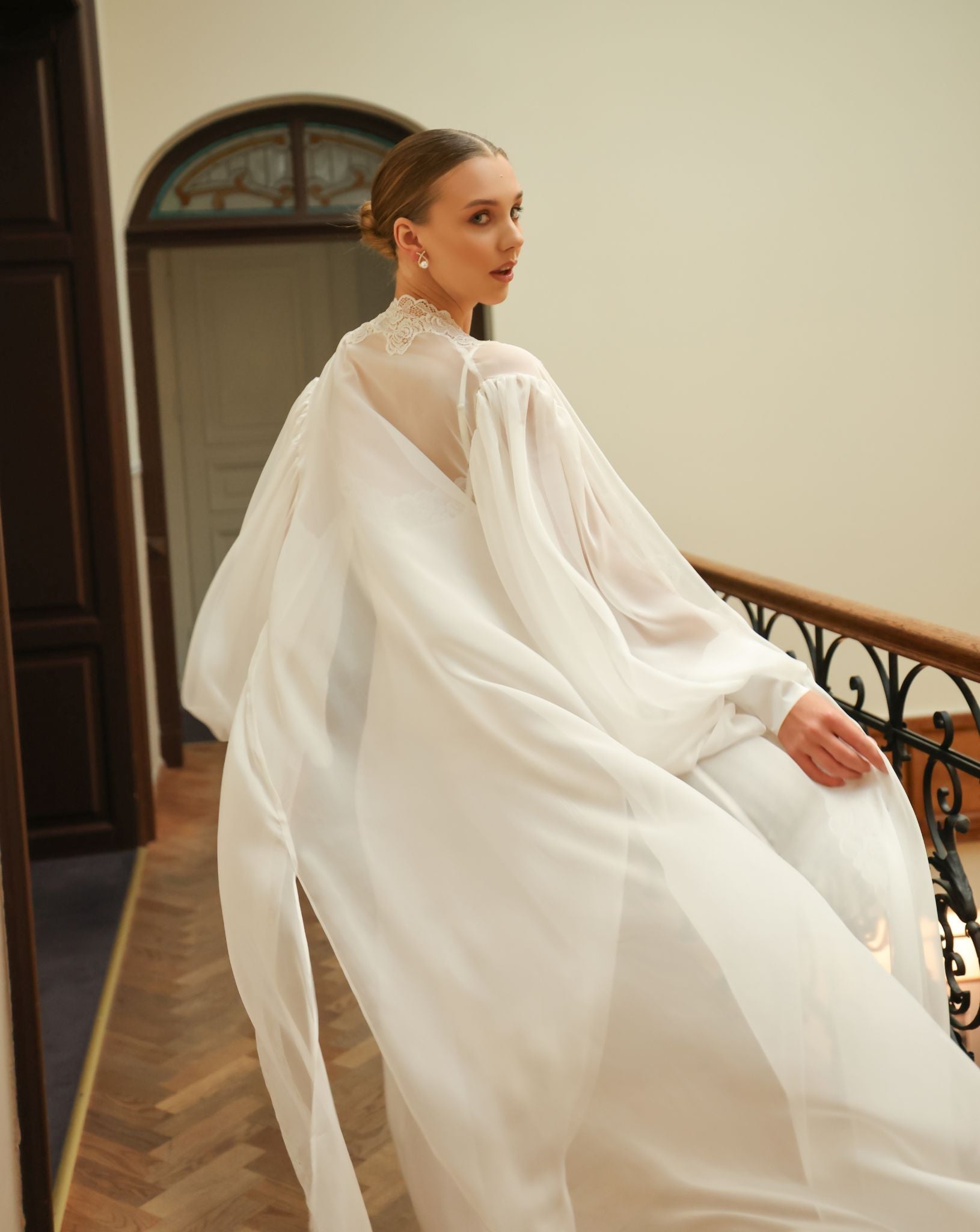Rear perspective of the flowing silk wrap, showcasing the graceful drape and the refined style of the puffy sleeves.