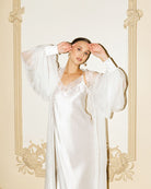 Mid-length shot of the sheer silk wrap with puffy sleeves, featuring silk cuffs and delicate button detailing.