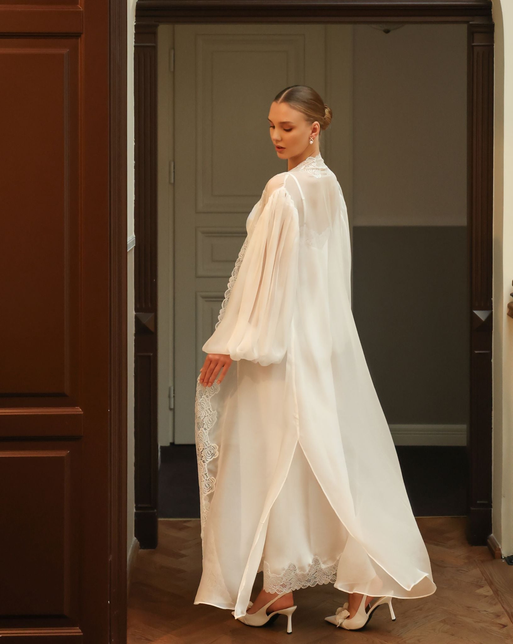 Full-length shot of the sheer robe in a playful twist, emphasizing the airy nature of the silk chiffon fabric.