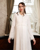 A mid-length view with hands down, emphasizing the modest cut and the seamless lace coverage across the silhouette.