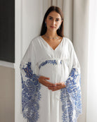 Frontal mid-length view of a woman holding her belly, showcasing the breathable cotton-blend fabric of the garment.
