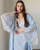 A mid-length shot focusing on the exquisite lace detailing and the elegant wide sleeves of the robe.