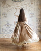 Rear view of the flowing robe in motion, showcasing the wide sleeves and the elegant drape of the satin.