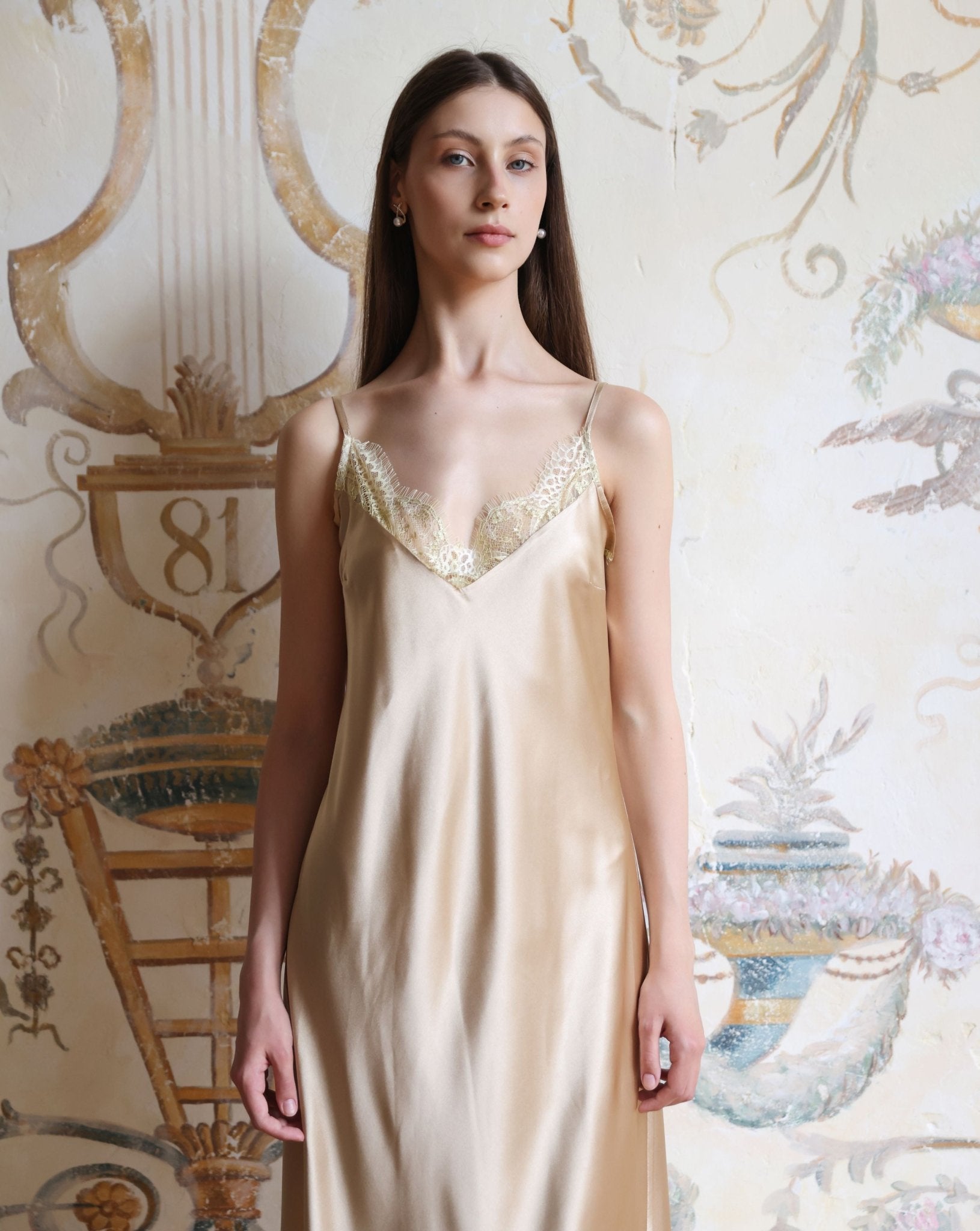 Mid-length frontal shot of the satin nightdress, showcasing the flowing lace-trimmed hem and smooth finish.