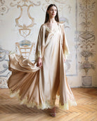 Frontal pose with a lifted robe hem, emphasizing the breathable fit and the consistent lace-trimmed design.