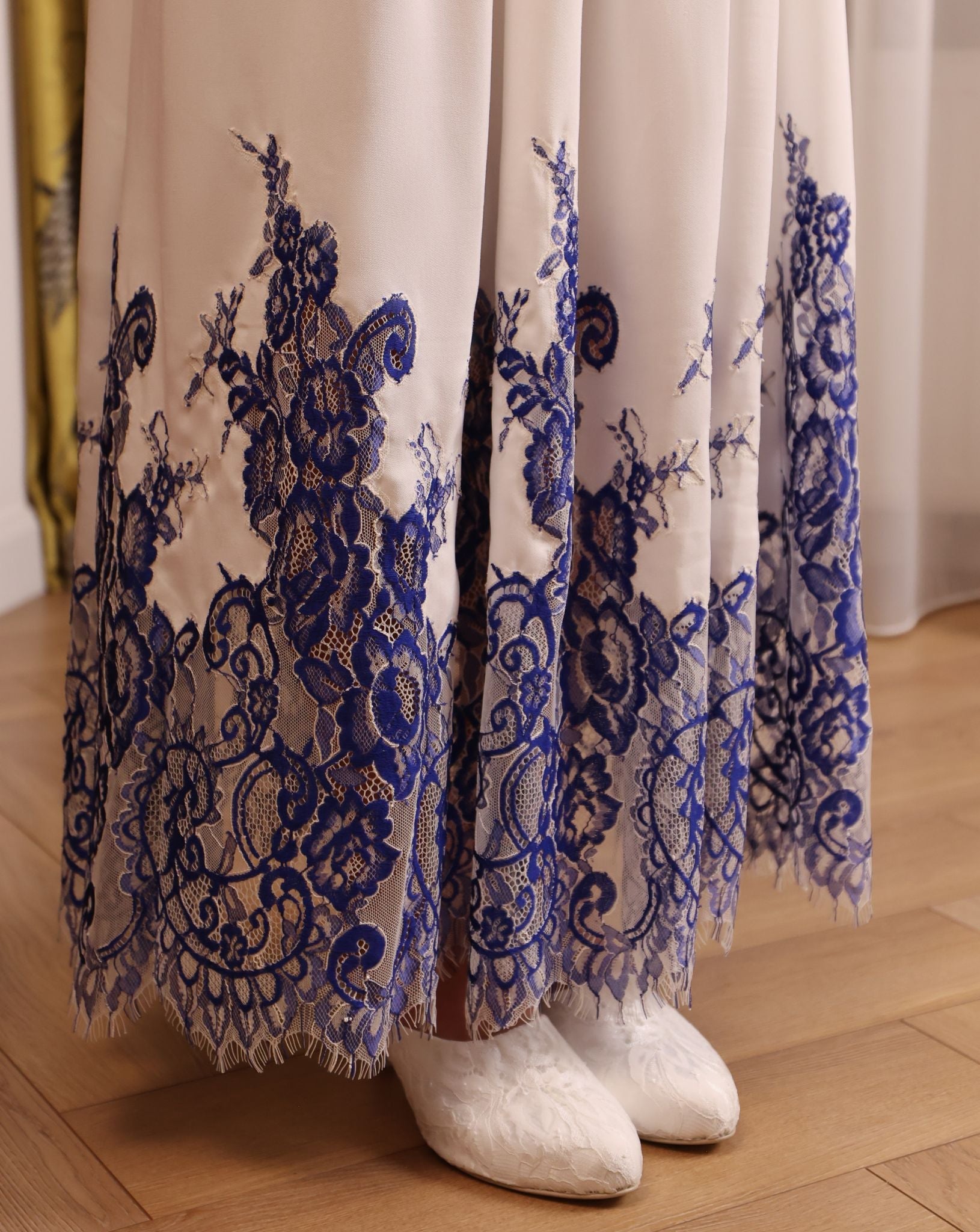 Close-up of the nightgown’s hem, showcasing the delicate French lace trim that adds a refined touch to the design.