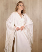 Mid-length view from head to knees, focusing on the wide sleeves and subtle lace detailing at the edges.