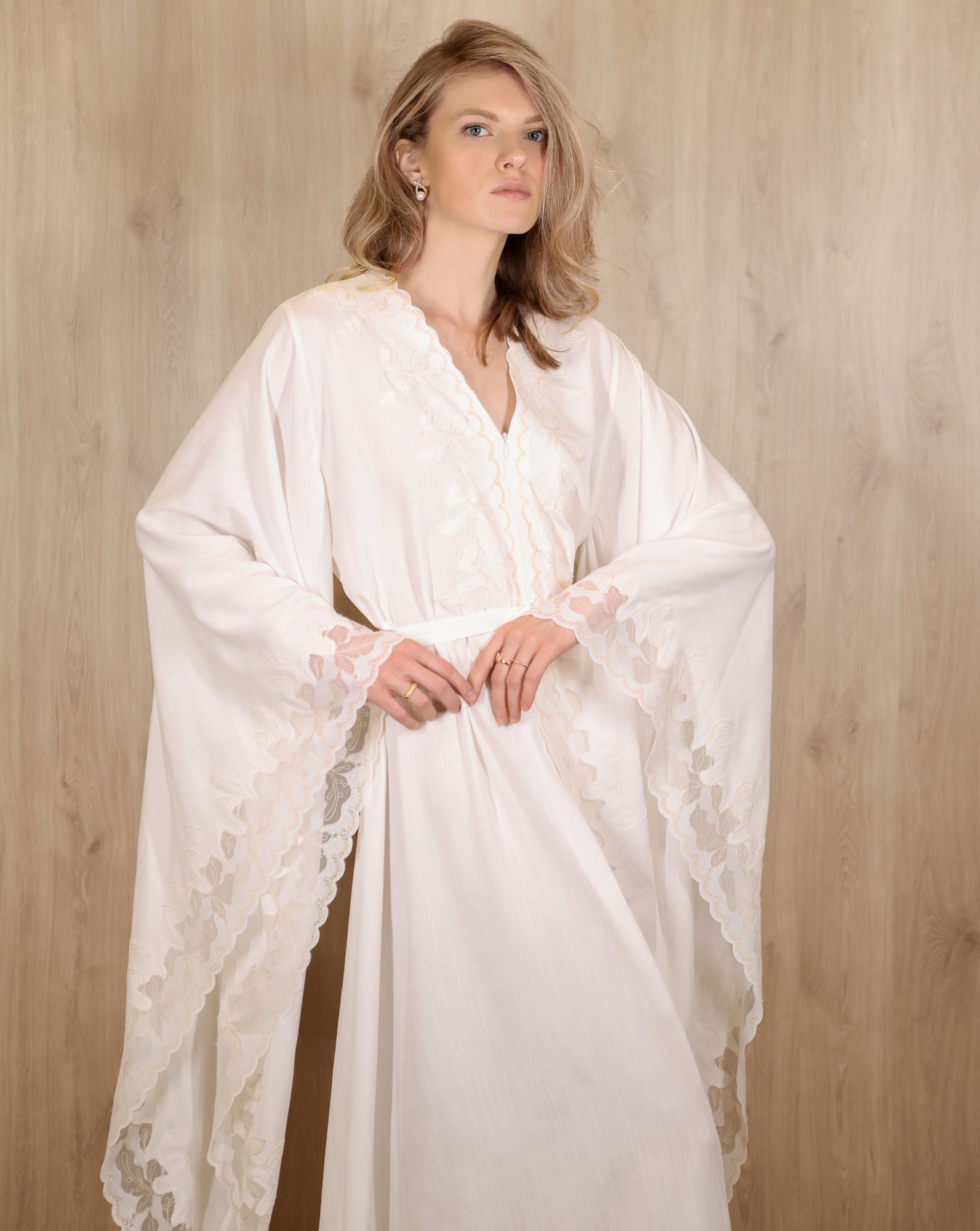 Mid-length view from head to knees, focusing on the wide sleeves and subtle lace detailing at the edges.