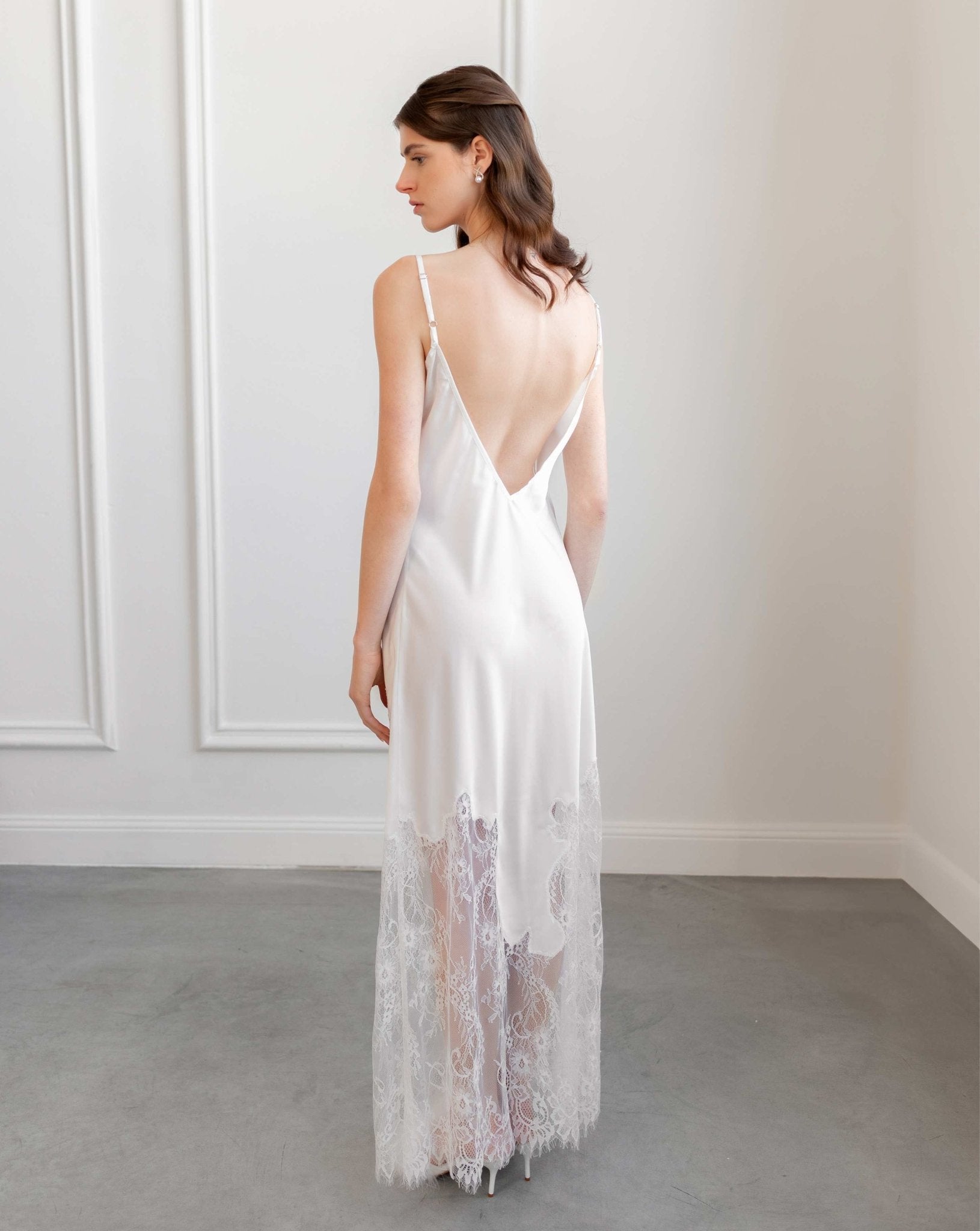 Back view of satin nightgown with lace train, photographed in daylight studio