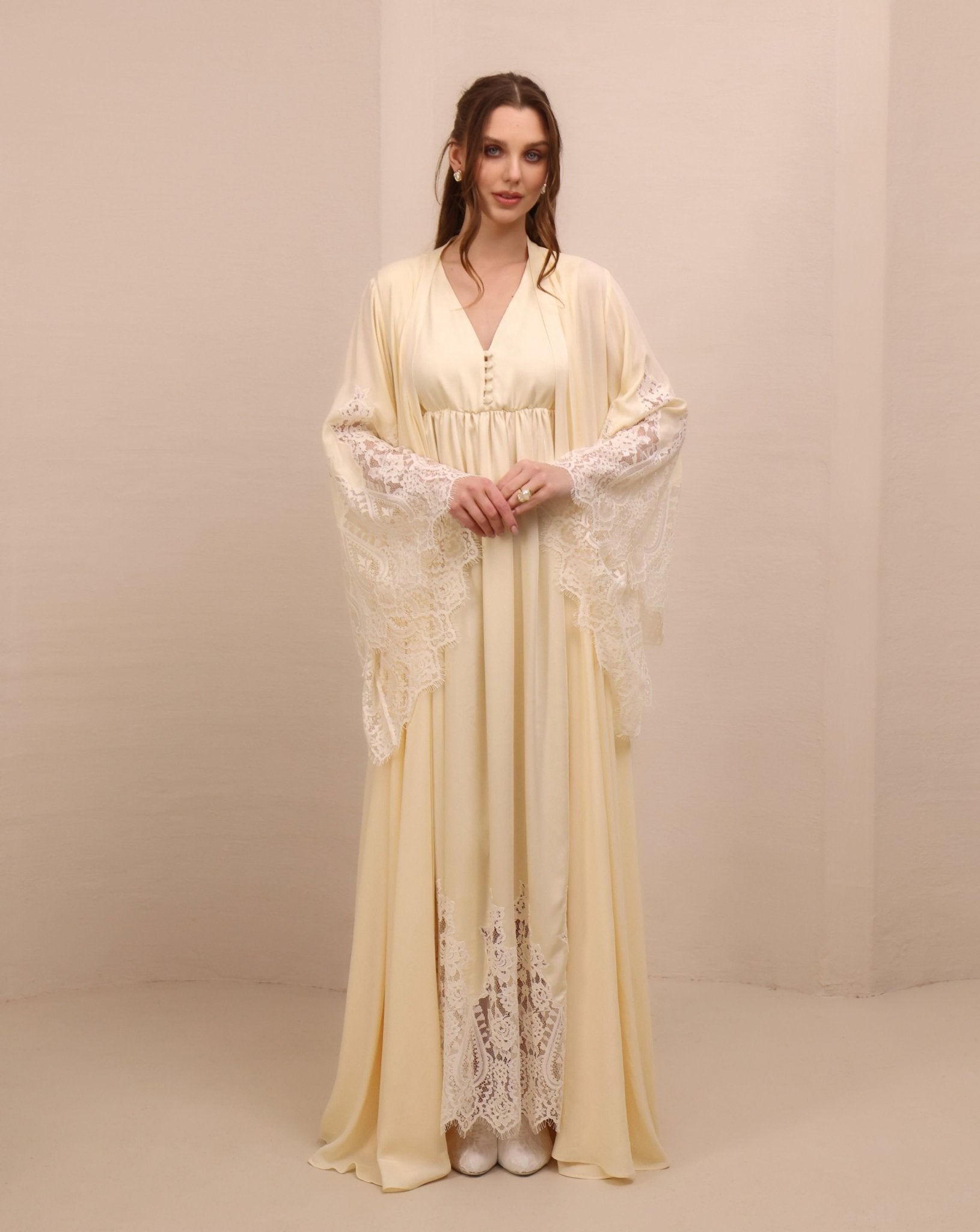 A frontal shot highlighting the wide lace-trimmed sleeves for added elegance and a timeless, graceful silhouette.