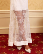 Close-up of the bottom hem, featuring beautiful floral lace that adds a romantic finish to the flowing silhouette.
