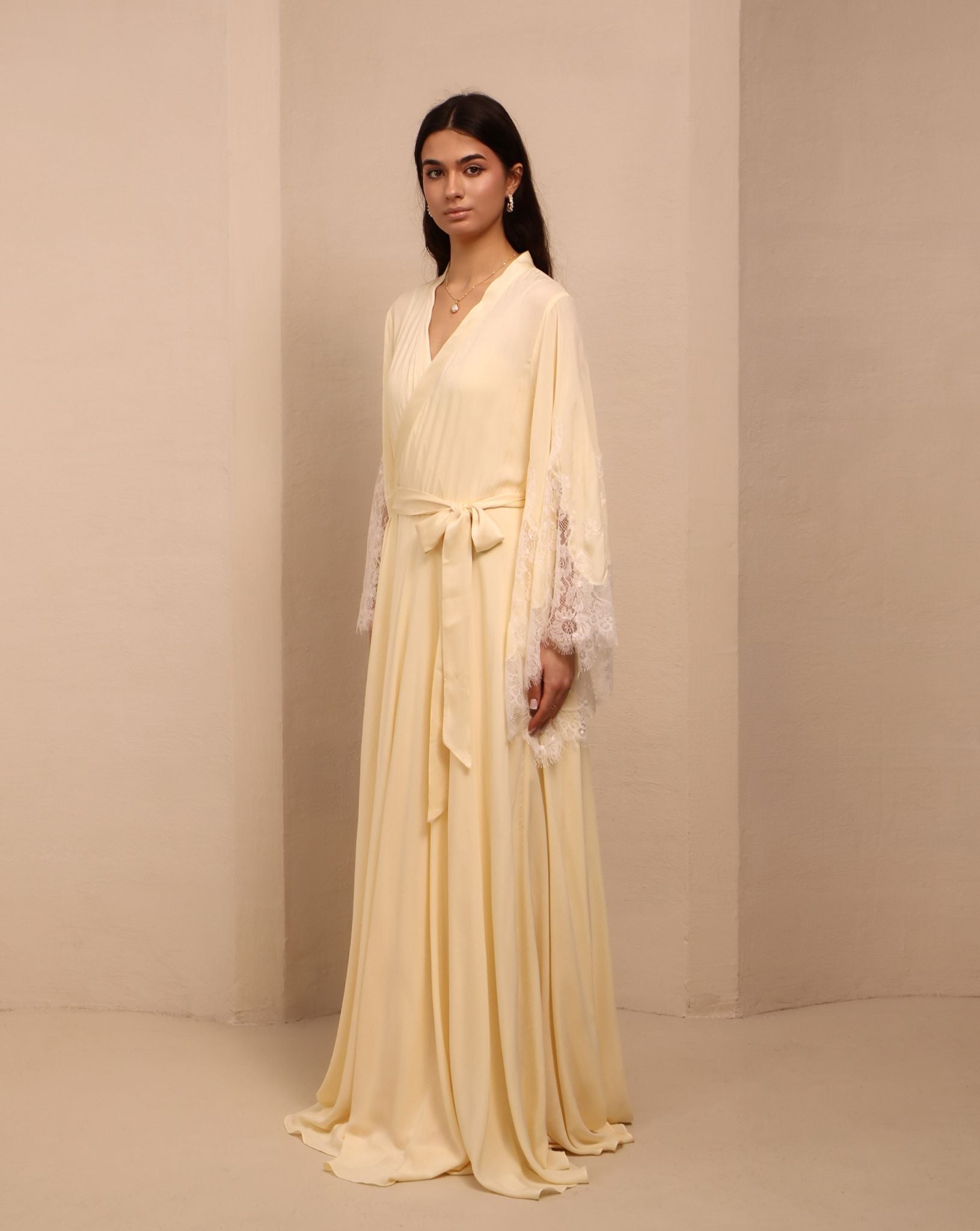 Side view of the tied ensemble, highlighting the long, graceful lines and the intricate lace detailing at the ends.