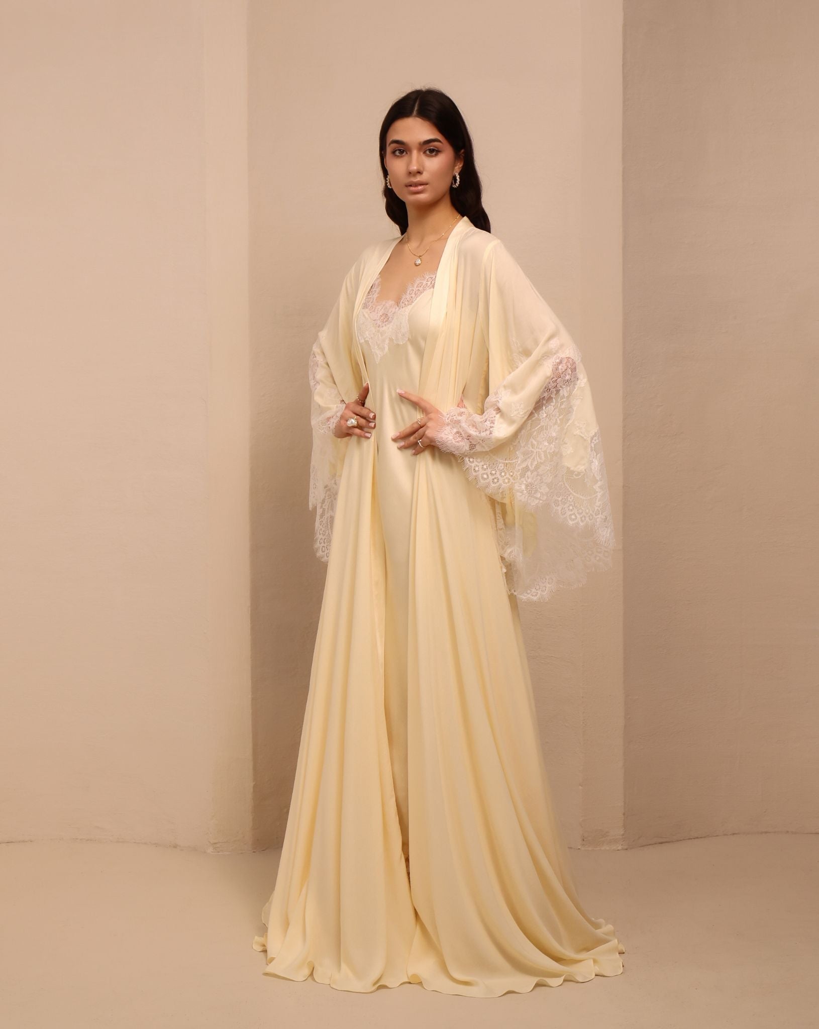 Side perspective of the attire, featuring small lace flowers sewn onto the fabric for a delicate touch.