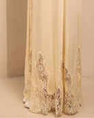 Close-up of the nightgown's hem, focusing on the soft lace patterns that add a layer of pure elegance to the design.