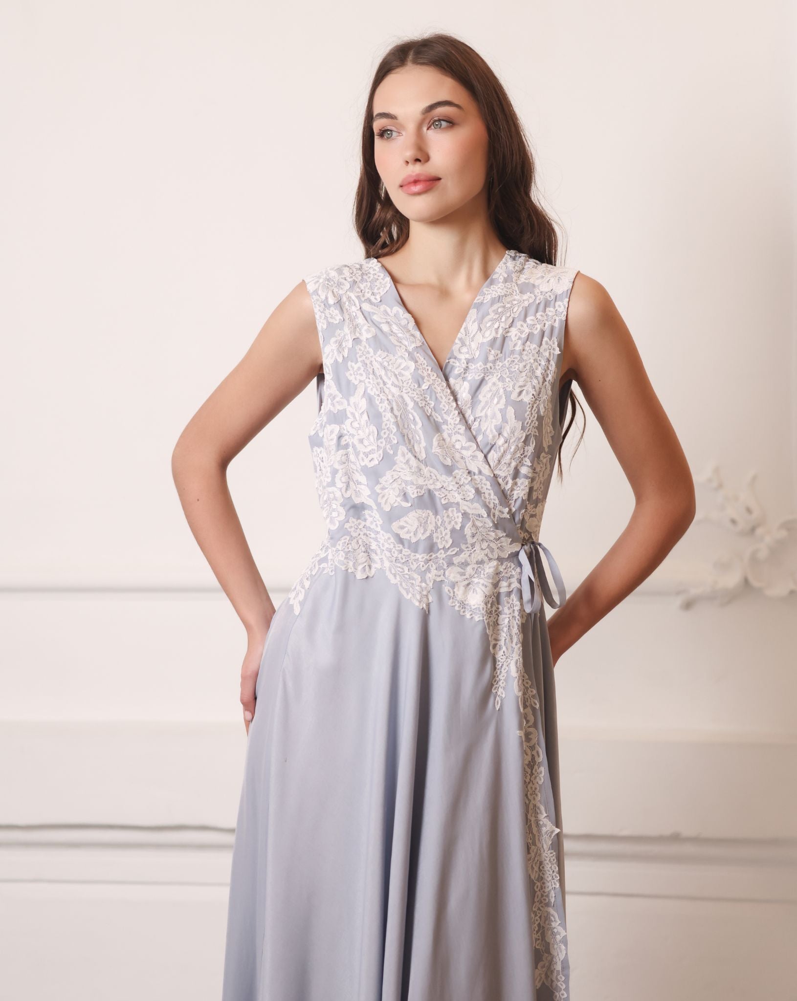 A focused shot of the nightgown with hands on hips, drawing attention to the intricate lace embellishments.