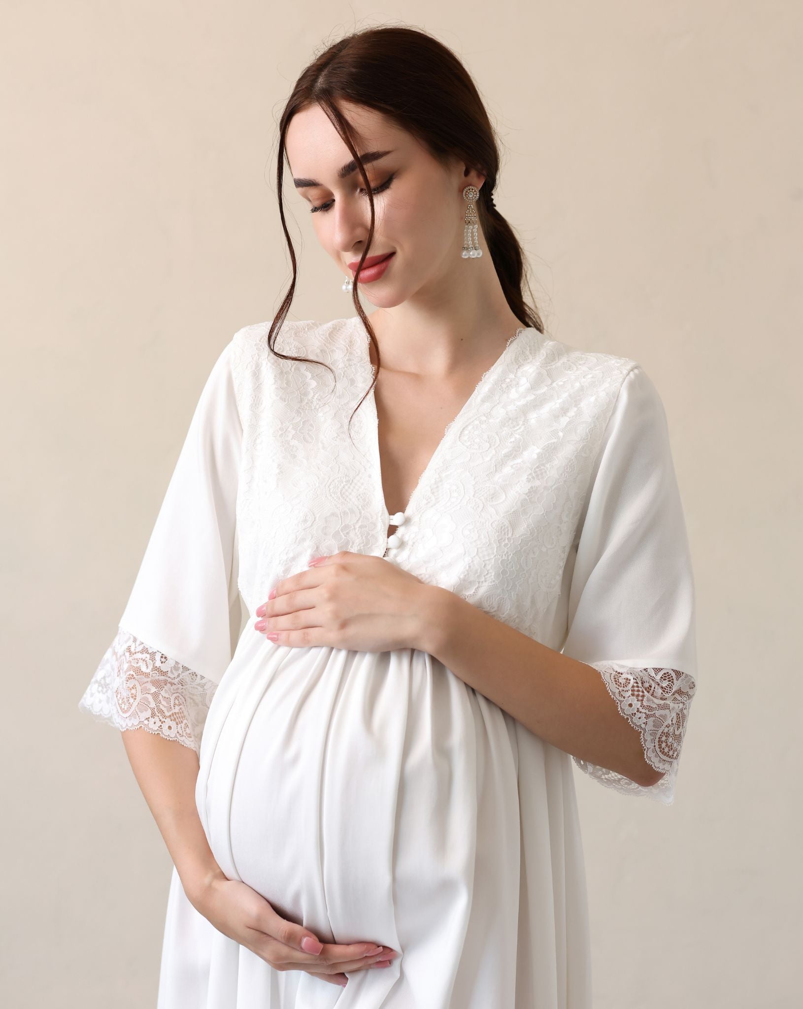 Mid-length shot focusing on the pregnancy bump and the gentle touch of the cotton-viscose blend on the skin.