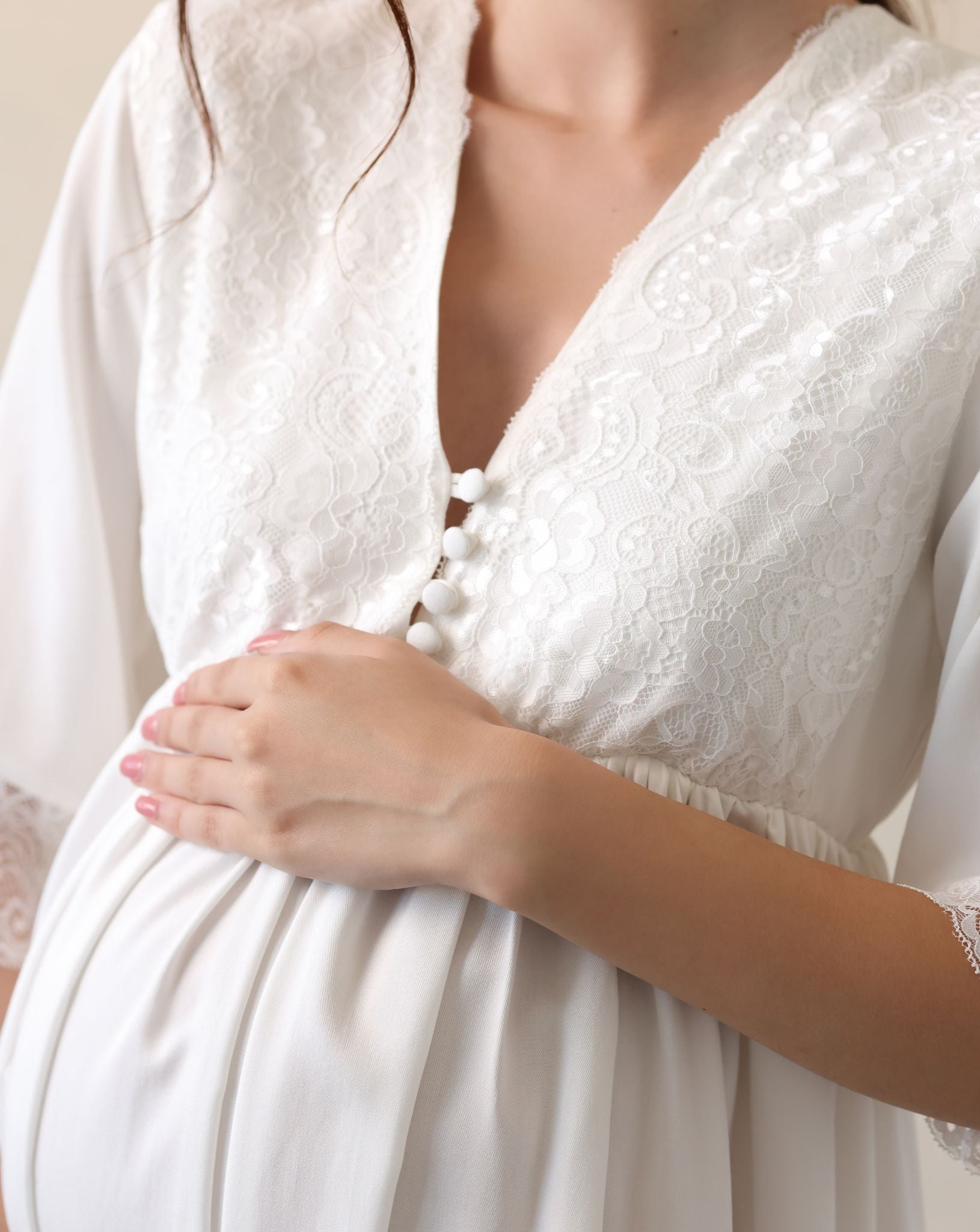 View of the lace-trimmed neckline and front buttons, designed for quick and easy nursing access during pregnancy.