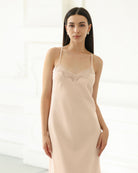 Close-up shot from head to hips of a nightgown with a lace-trimmed neckline and adjustable shoulder straps.