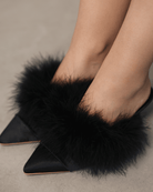 A top-down view of the elegant footwear on the feet, showcasing the plush texture and feminine finish.
