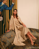 An atmospheric shot of the set on a sofa, capturing the mineral warmth and intimate feel of the breathable cotton.