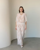 A full-length motion shot of the Cotton Pyjamas, showcasing the gentle drape and refined silhouette.