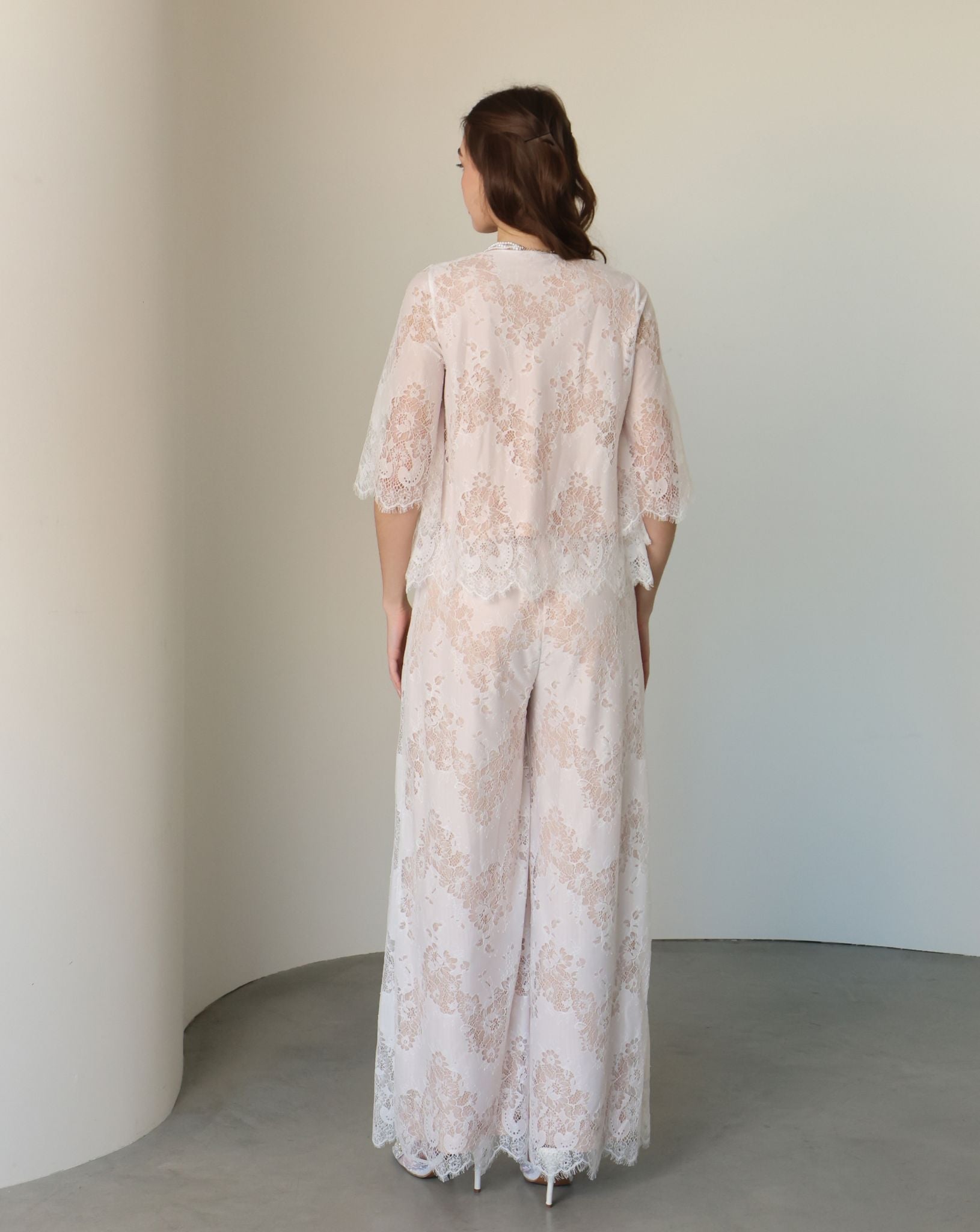 Rear view of the set, showcasing the wide lace-trimmed trousers and the airy, romantic design.
