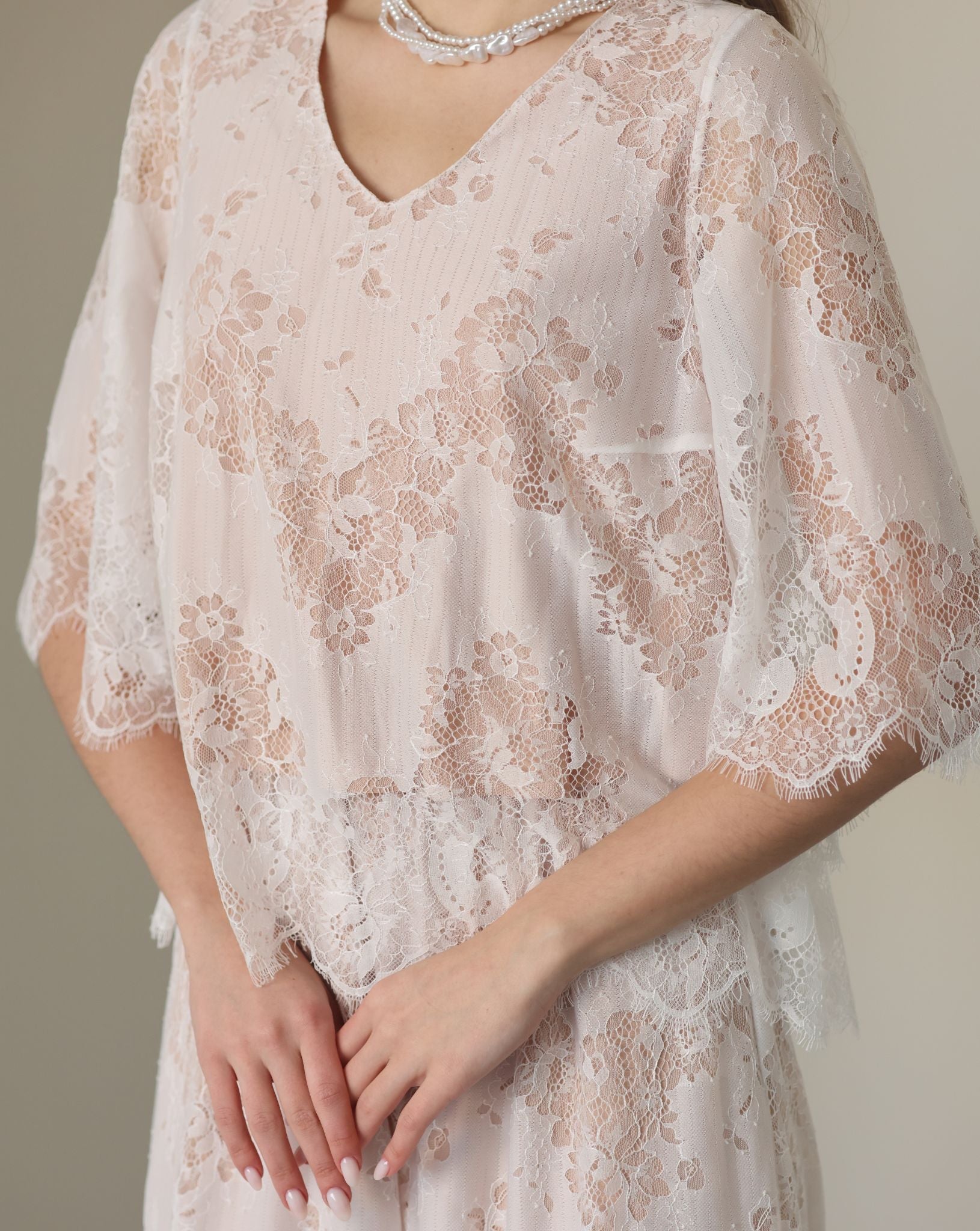 A detailed shot of the flowing top, focusing on the subtle floral patterns and breathable cotton lining.