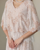 A detailed shot of the flowing top, focusing on the subtle floral patterns and breathable cotton lining.