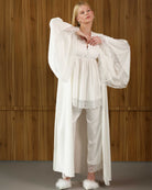 Model lifting arms in flowing cotton robe over pajama set – Kafemme