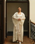 Standing full-length pose focusing on the wide sleeves adorned with exquisite lace inserts for a refined look.