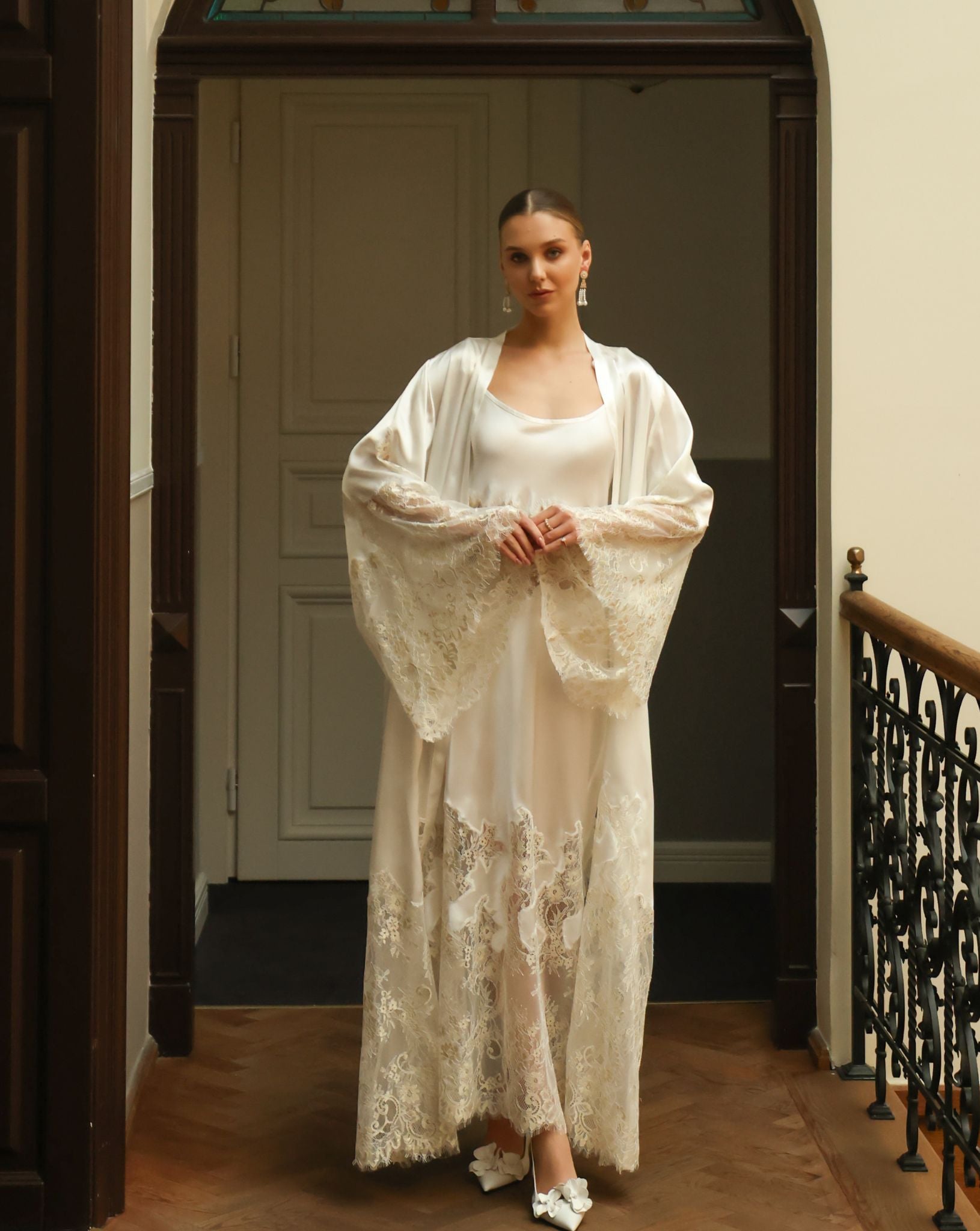Standing full-length pose focusing on the wide sleeves adorned with exquisite lace inserts for a refined look.