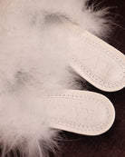 Close-up of the genuine leather insole with soft padding and the brand logo for a sense of quiet luxury.