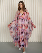 Front view with slightly raised arms to display the artistic floral design and structural cut of the silk sleeves.