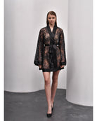 Model standing in black lace kimono with V neckline